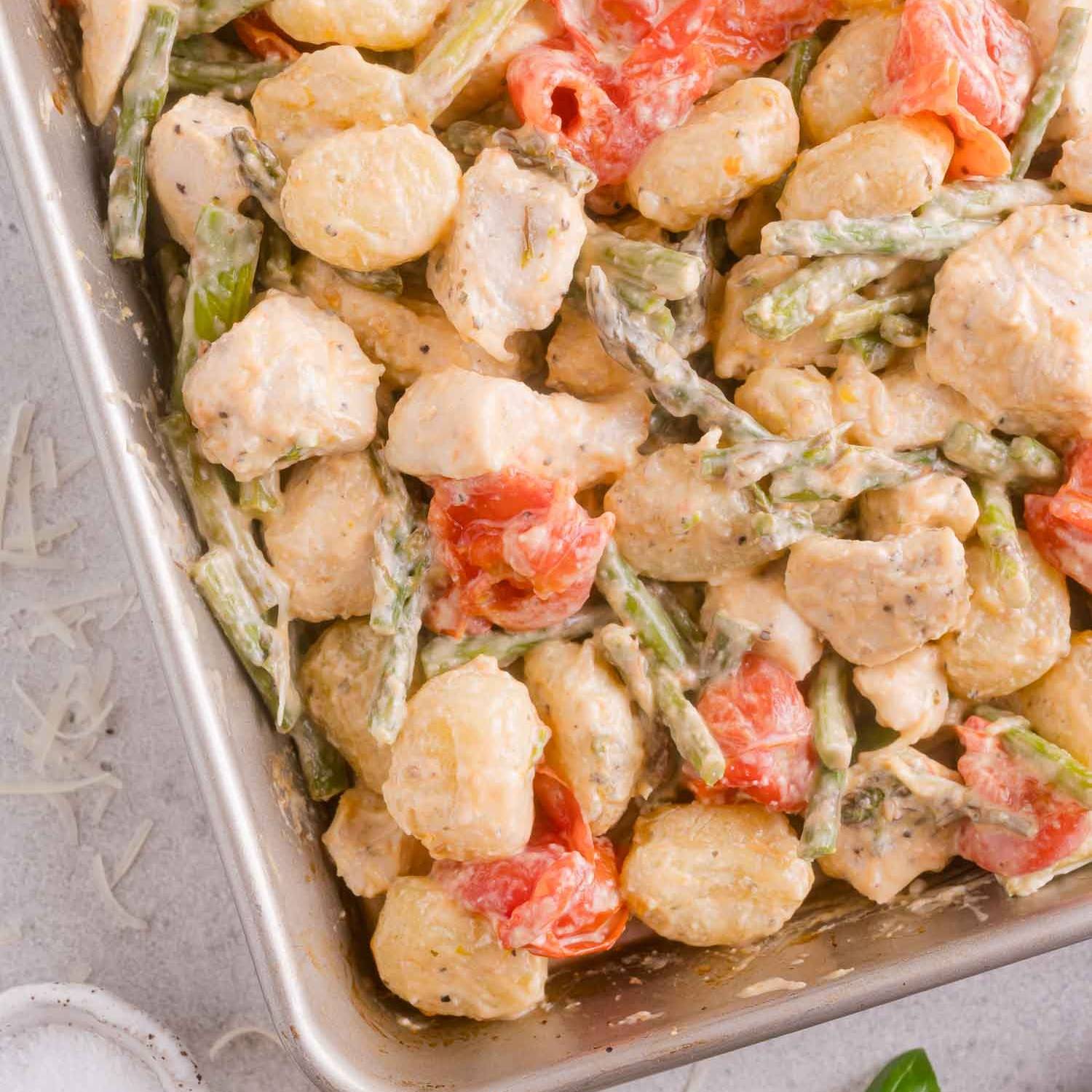 Sheet pan dinner with gnocchi, vegetables, and a creamy sauce.