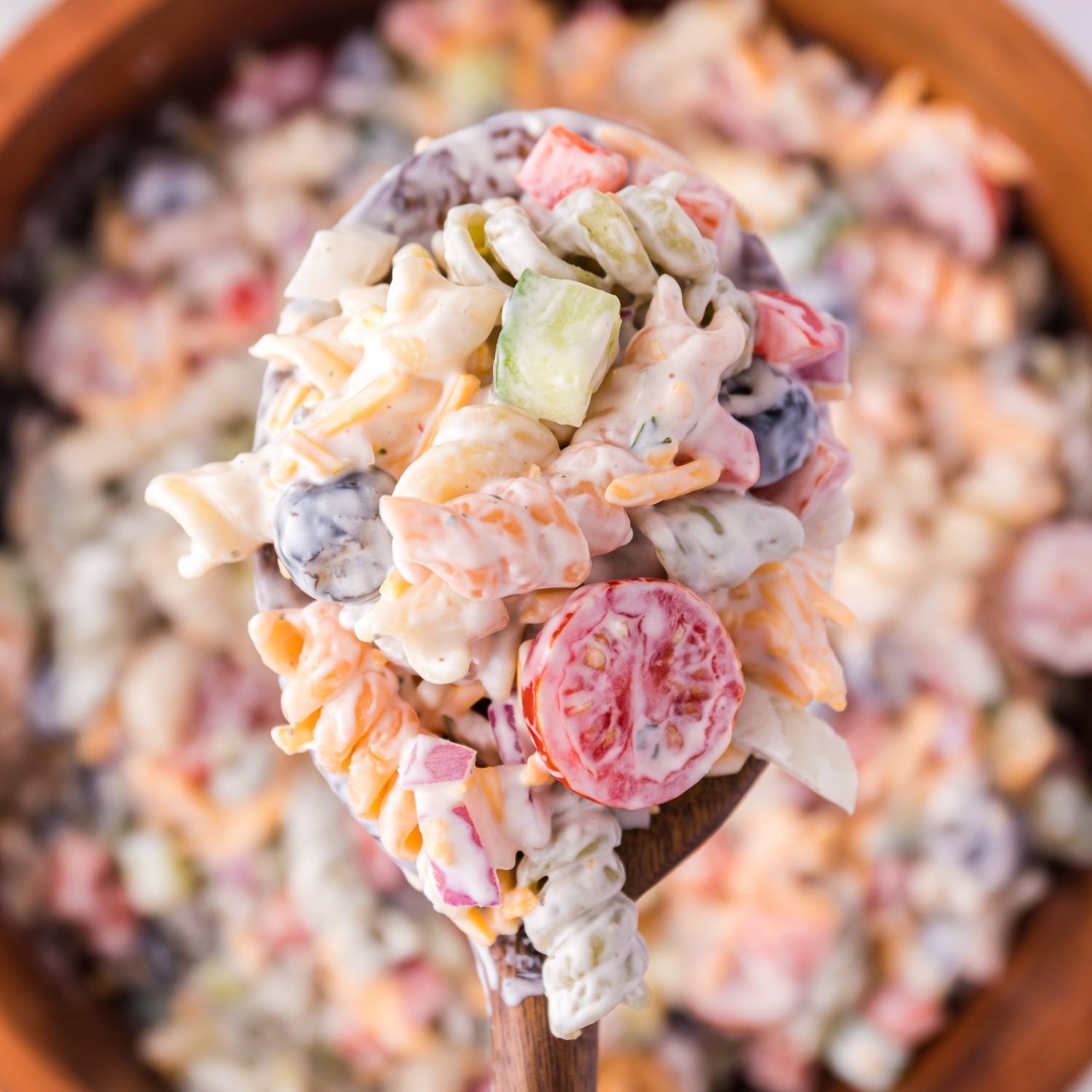 Ranch pasta salad in a wooden bowl.