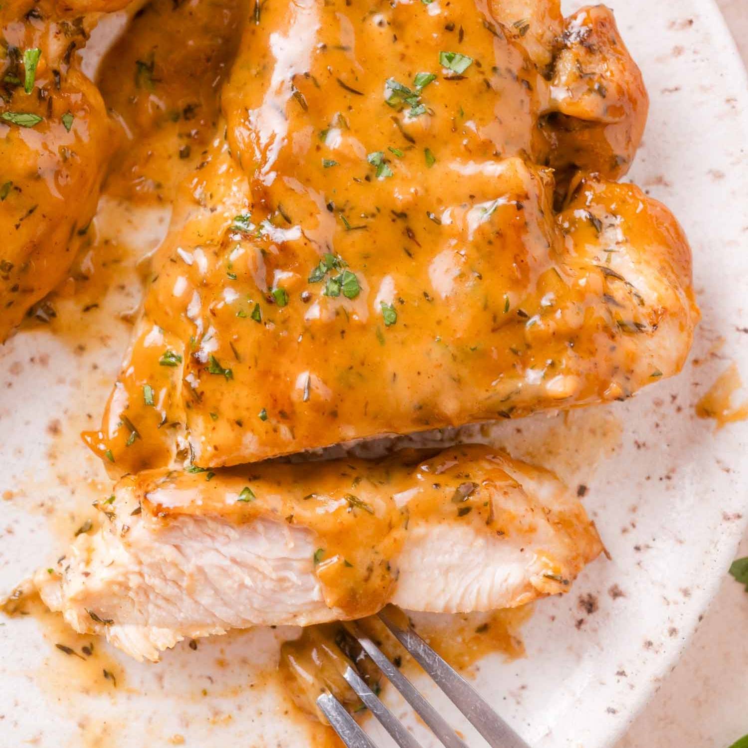 Sliced chicken with apple cider cream sauce, light brown in color.