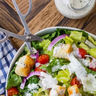 A green salad, topped with creamy Italian dressing. 
