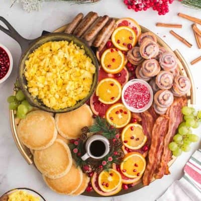 Beautiful brunch board with eggs and cinnamon rolls.