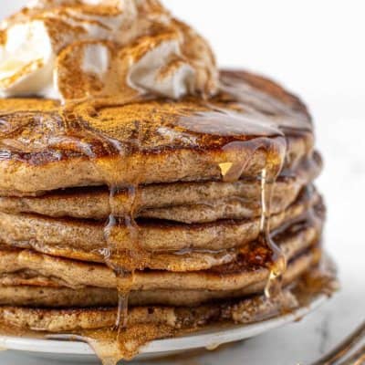 stack of eggnog pancakes dripping with syrup.