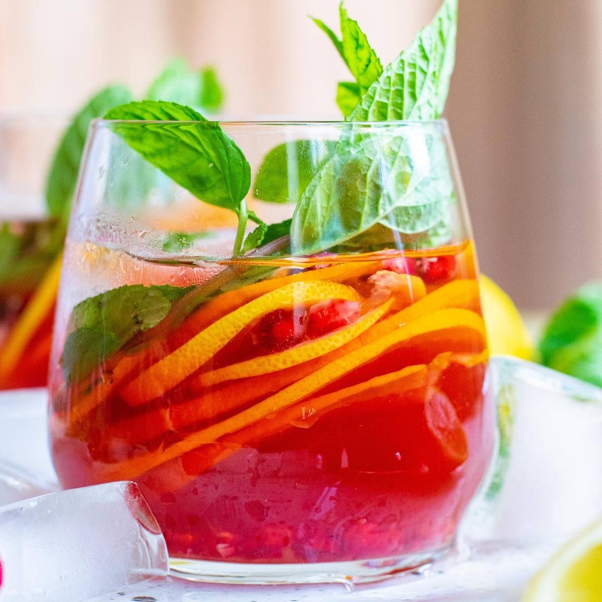 Sparkling pomegranate punch in a stemless wine glass.