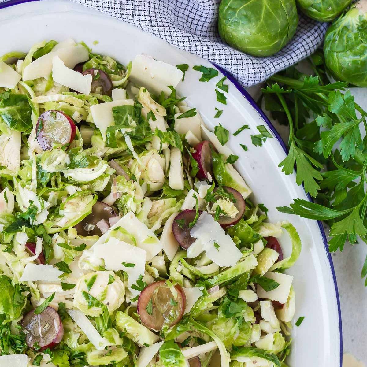 Shaved Brussels sprouts salad with grapes and minced parsley.