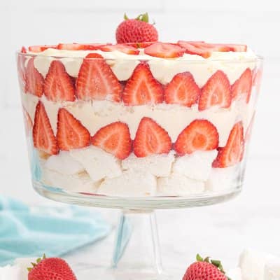 Layered strawberry trifle in a trifle bowl.