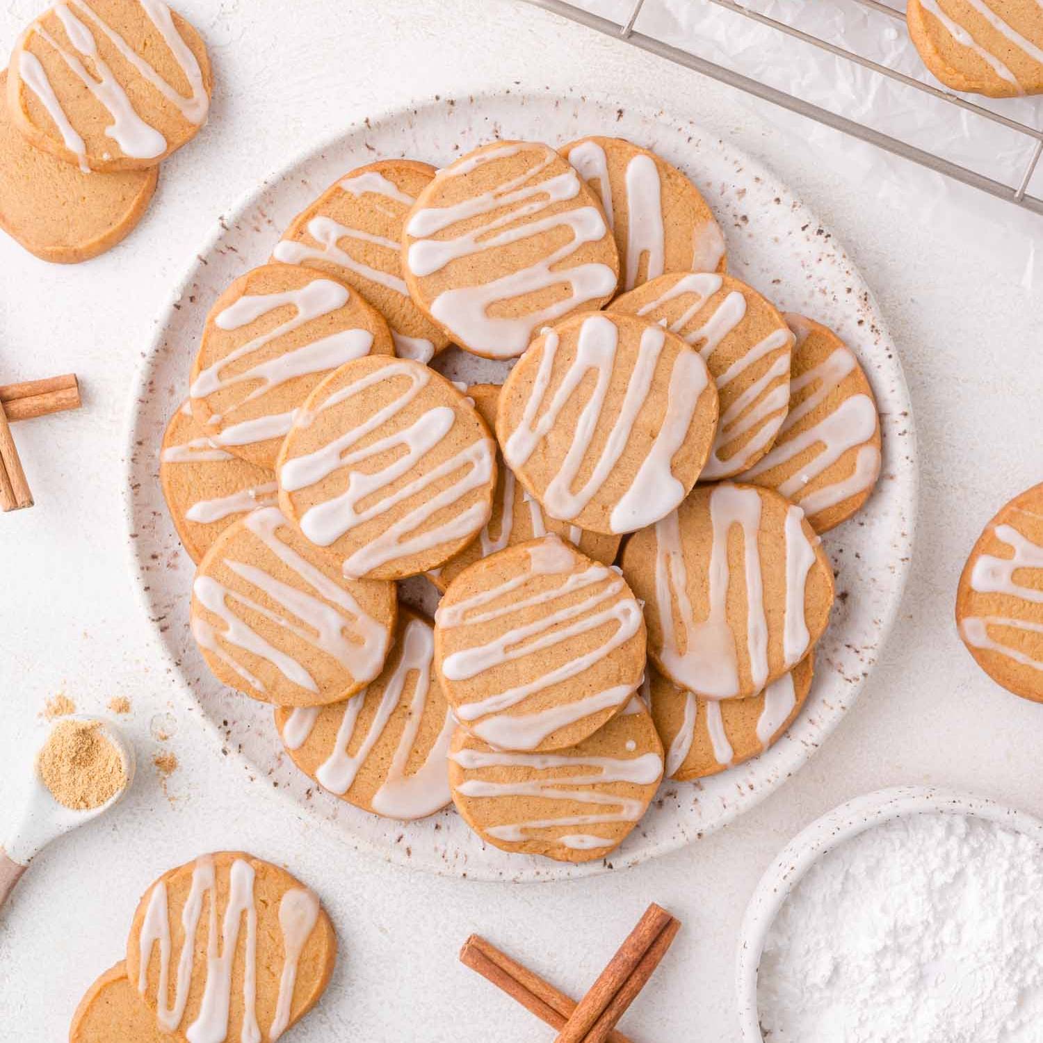 Round gingerbread shortbread cookies on a plate.