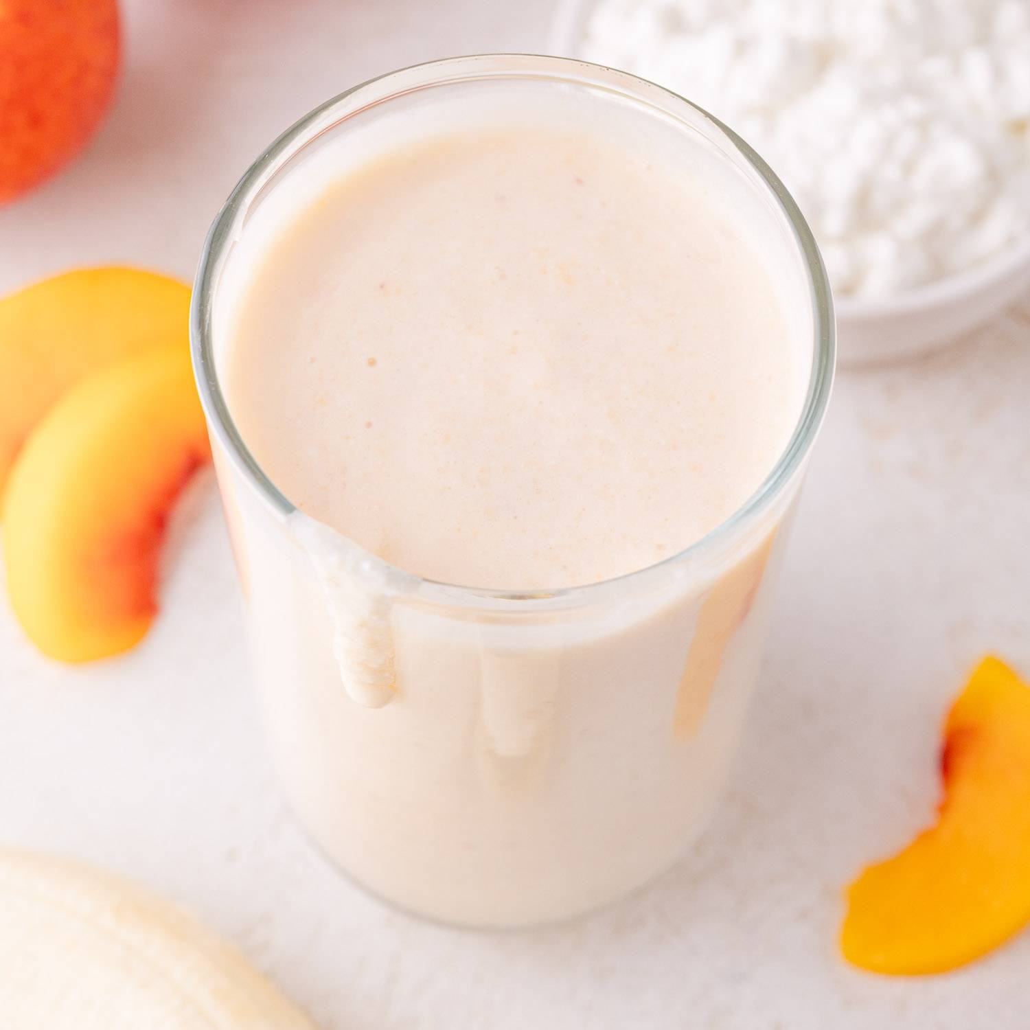 Light orange cottage cheese smoothie viewed from above.