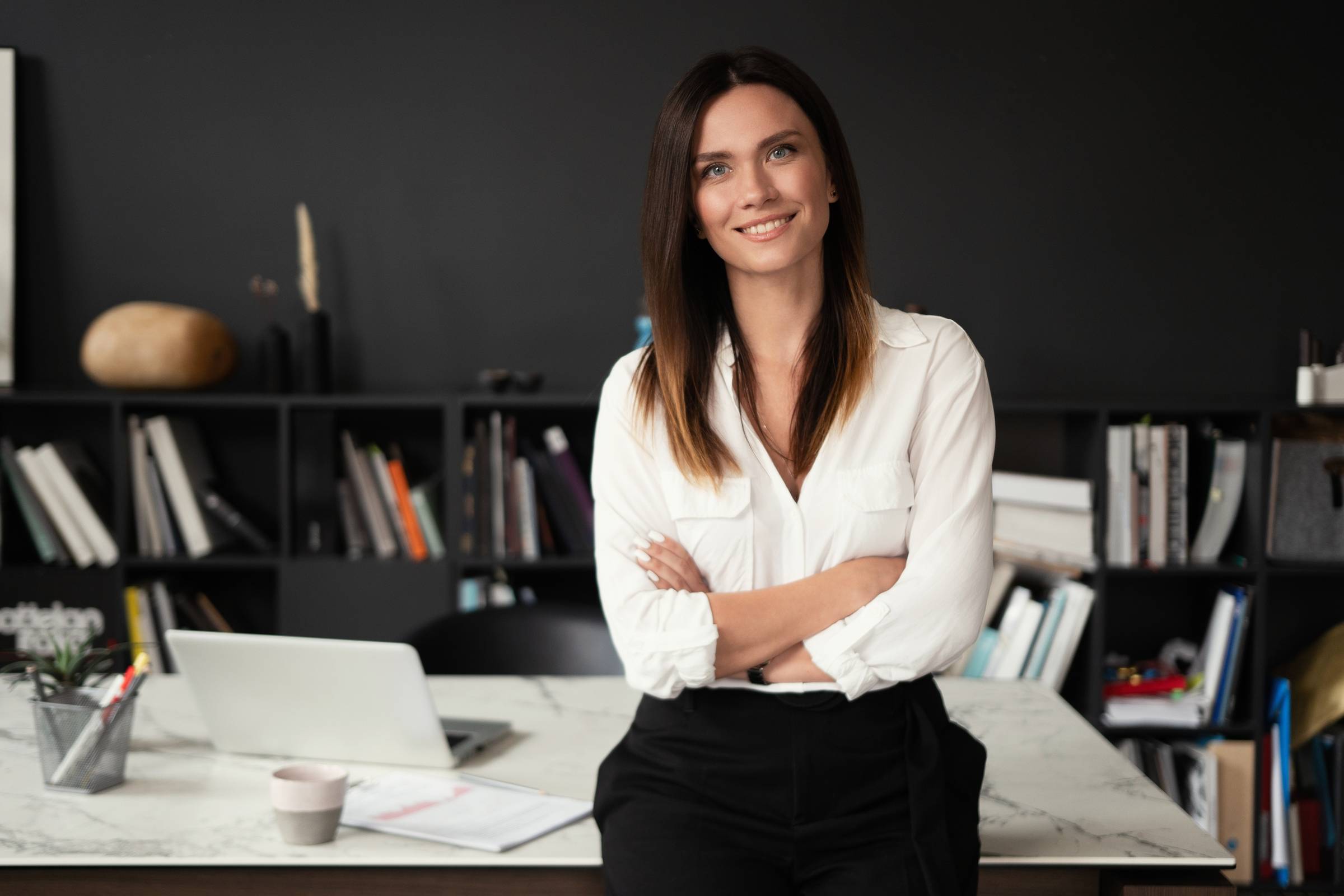 Confident stylish european middle aged woman standing at workplace, 30s lady executive leader manager looking at camera.jpeg