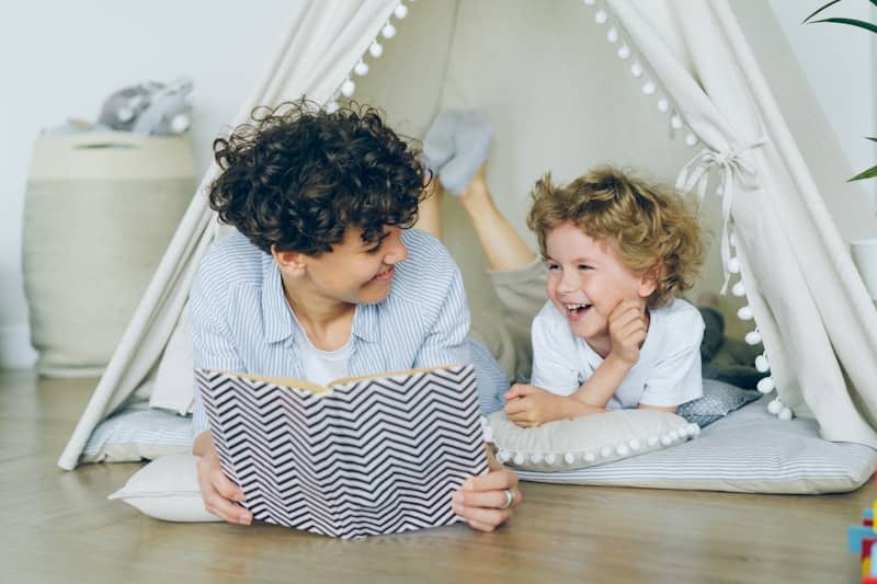 a woman reading a book to a child