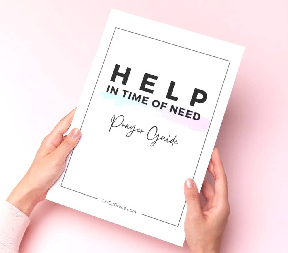 woman using Help In Time of Need Prayer Guide on table