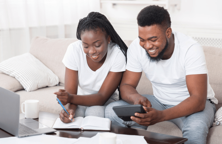 A couple happily talking about money