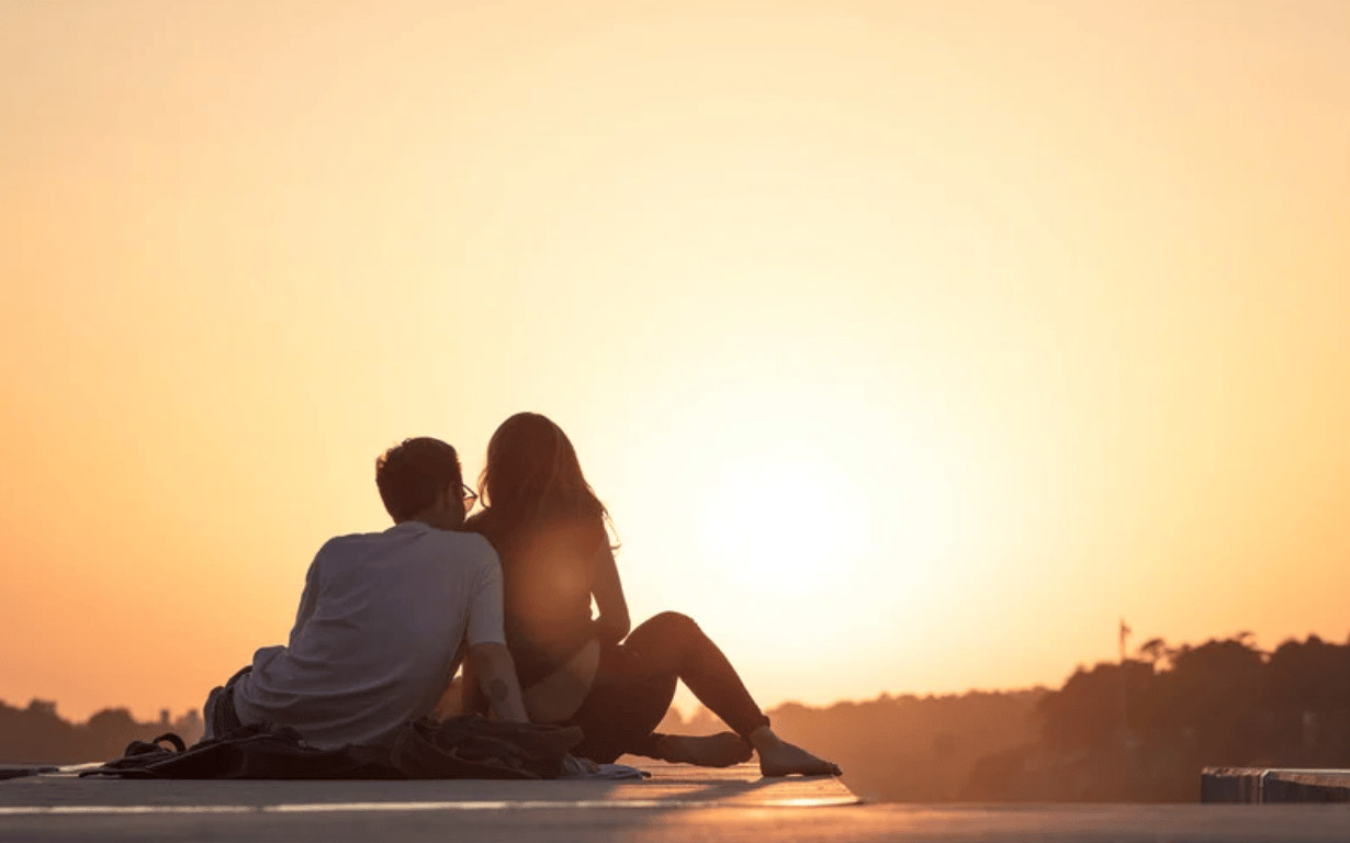 A loving couple watching the sunset