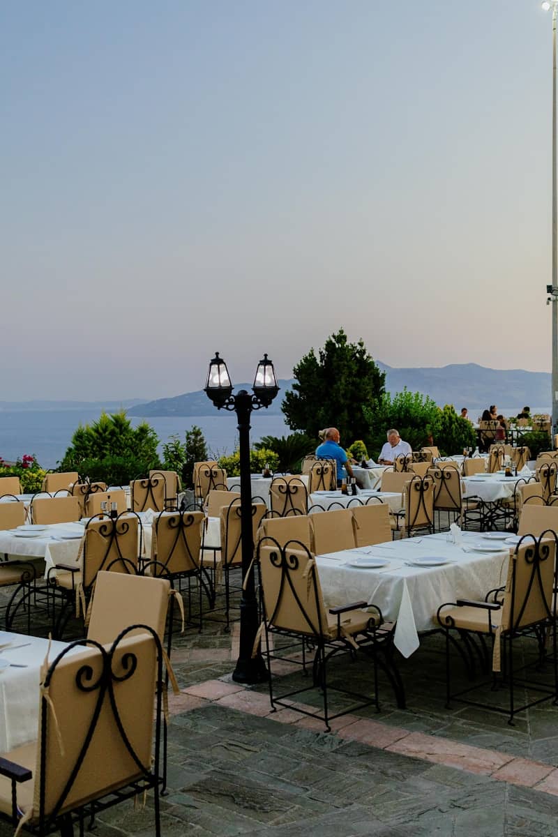 Restaurant patio with tables overlooking the water.