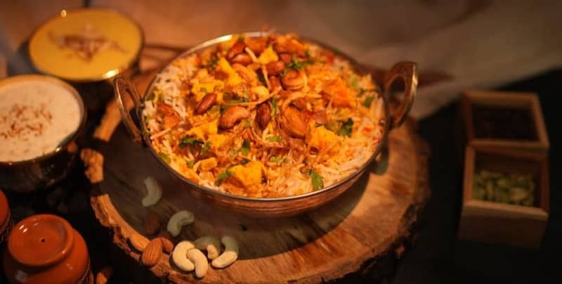 A round dish filled with food and toppings.