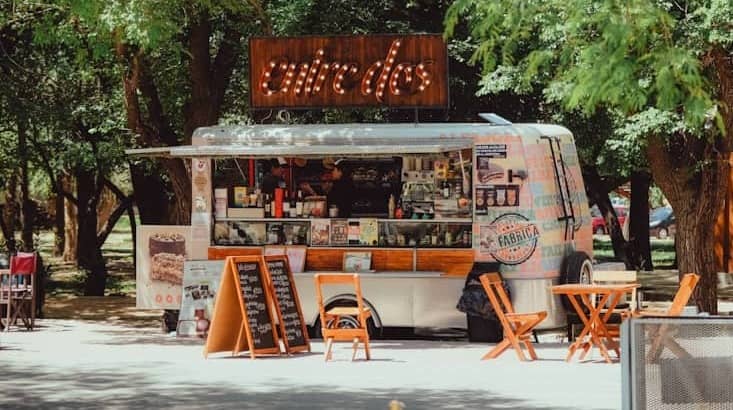 Food truck with outdoor seating under trees