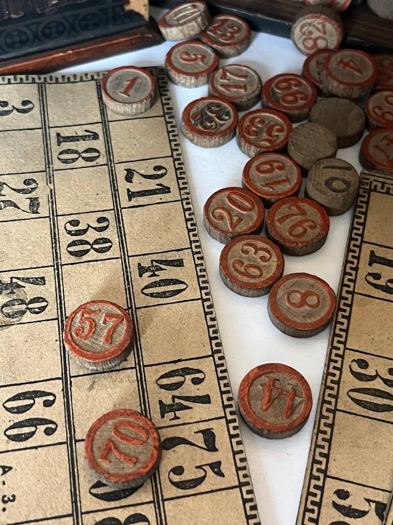 Vintage bingo cards and numbered wooden tokens.