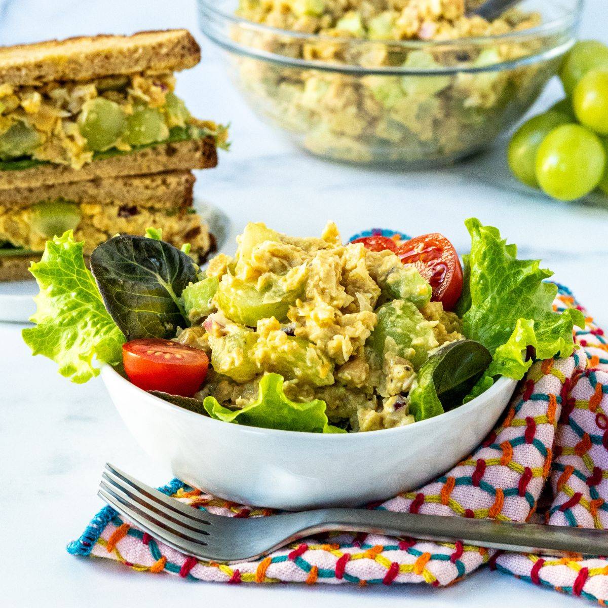 Chickpea salad on a green salad and in a sandwich.