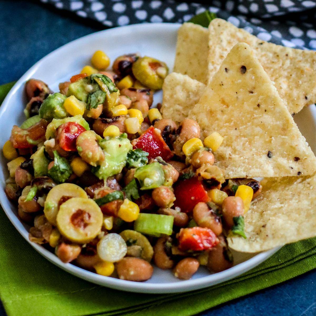 Plate of black eyed pea dip and tortilla chips.