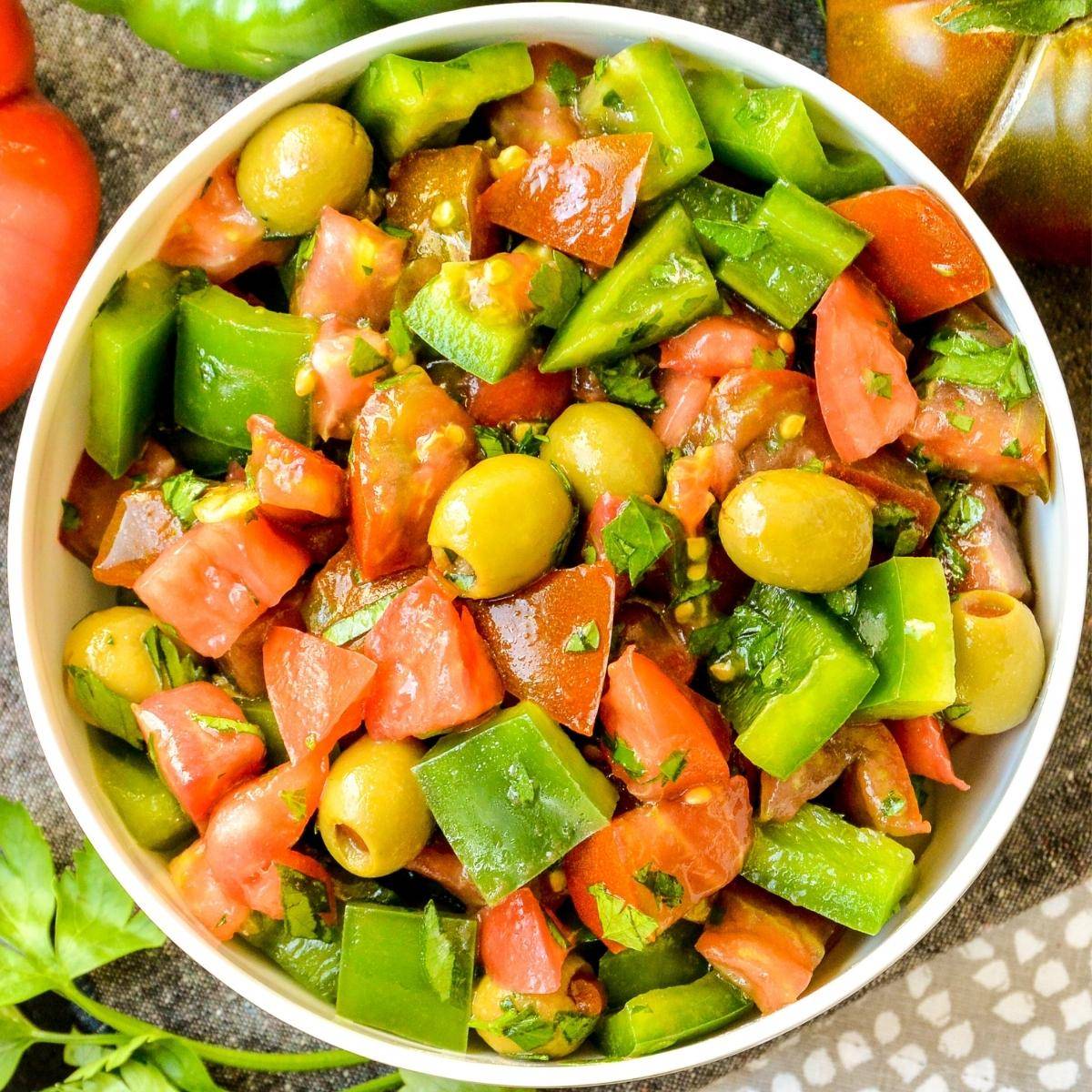 Green pepper salad with tomatoes and green olives.