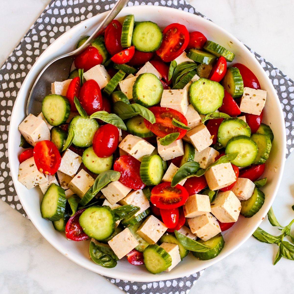 Tomato basil cucumber salad with vegan feta.