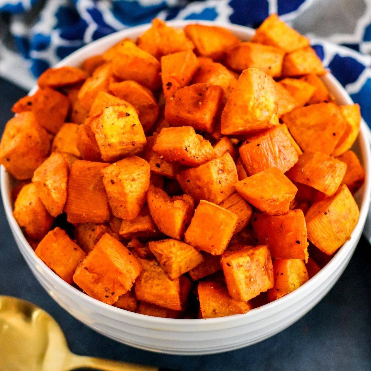 Bowl of roasted sweet potato cubes.