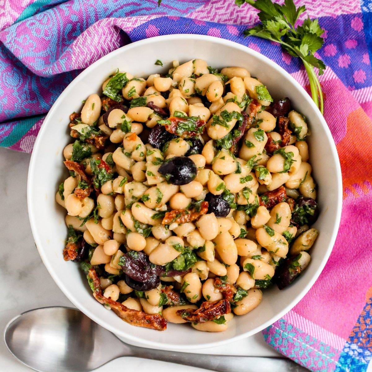 Bowl of sun-dried tomato cannellini bean salad.