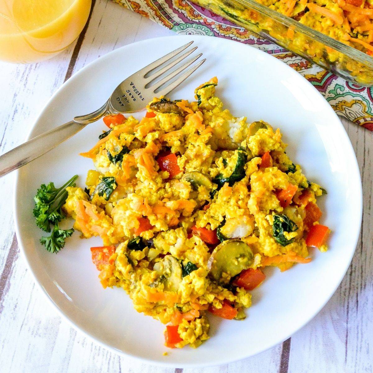 Serving of Vegan Breakfast Casserole on a plate with a fork.
