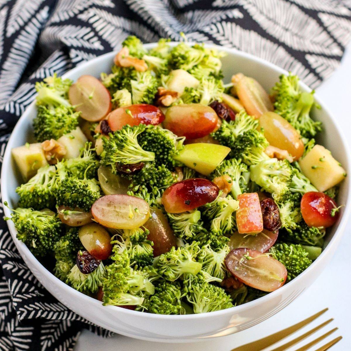 Broccoli salad with grapes, apples, cranberries, and walnuts.