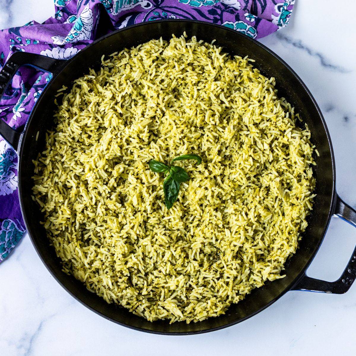 Baked pesto basmati rice in a skillet.