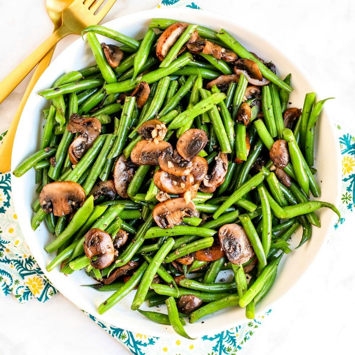 Platter of sauteed green beans with mushrooms.