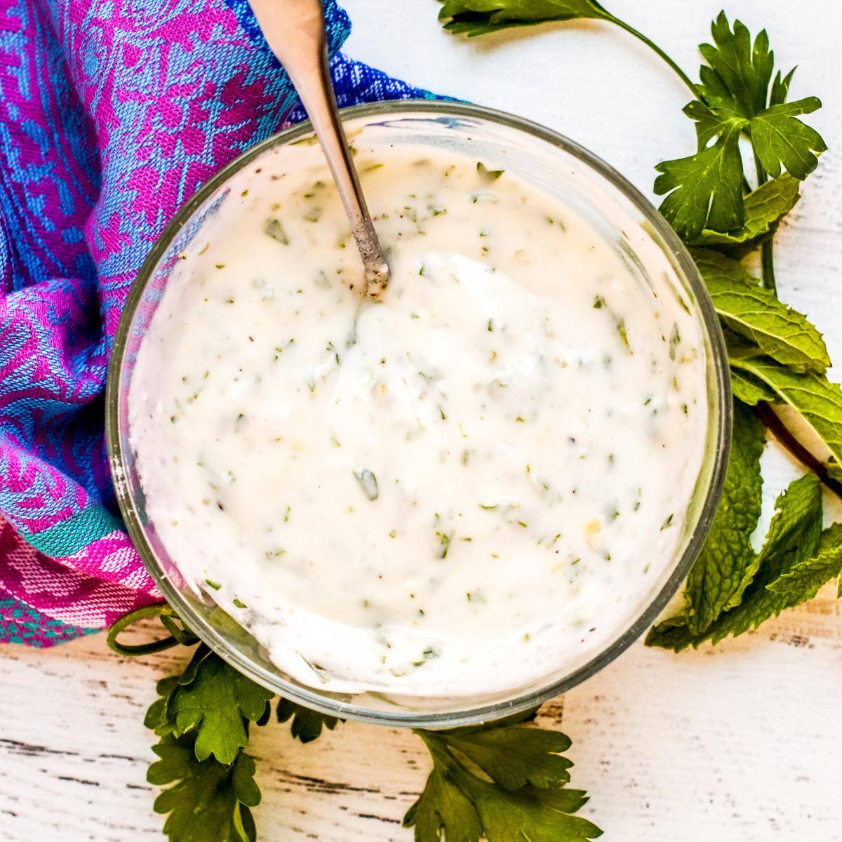 Bowl of garlic herb vegan yogurt sauce.