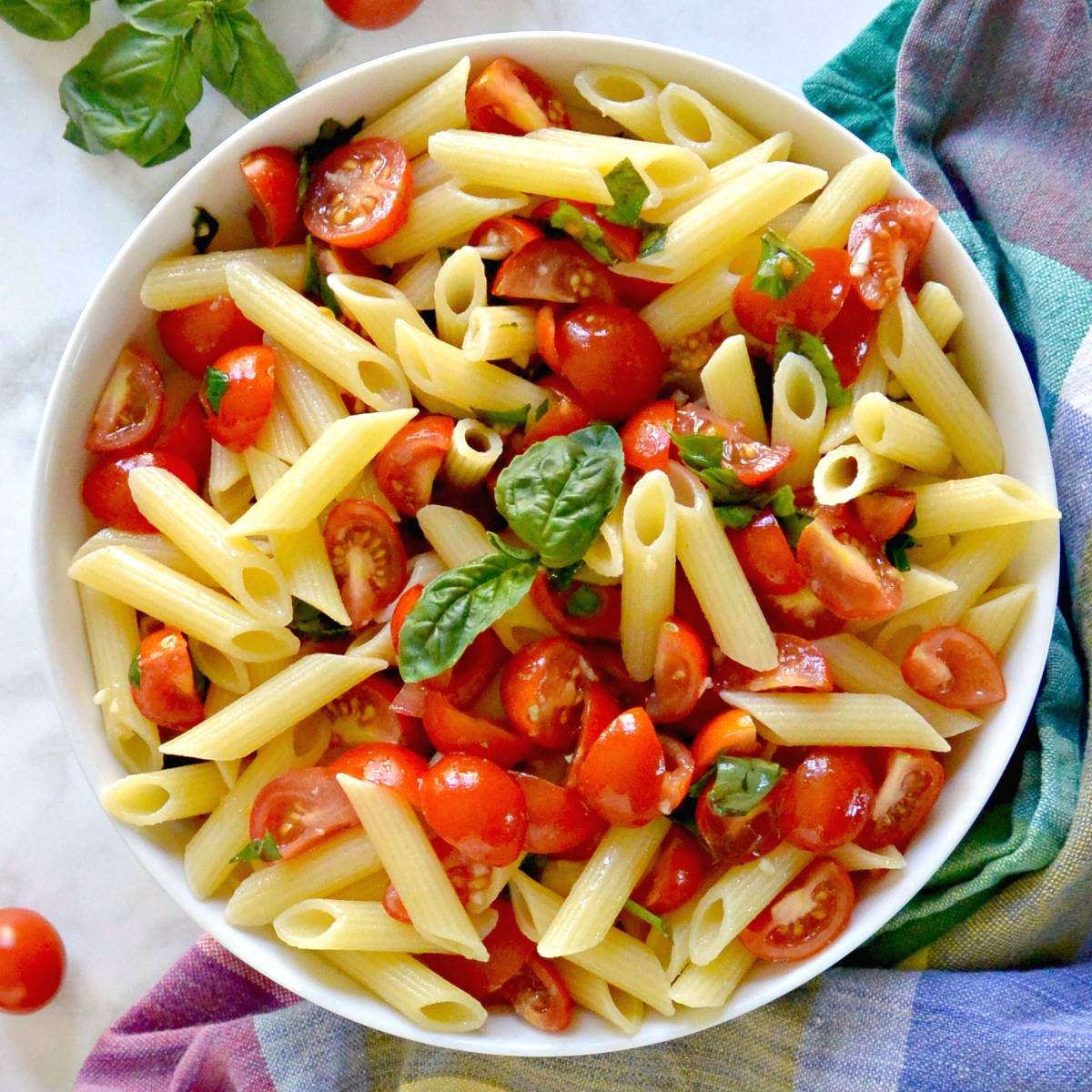 Penne tossed with no-cook cherry tomato sauce and garnished with fresh basil.