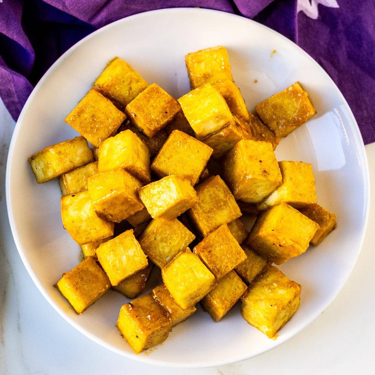 Cubes of maple Dijon tofu on a plate.
