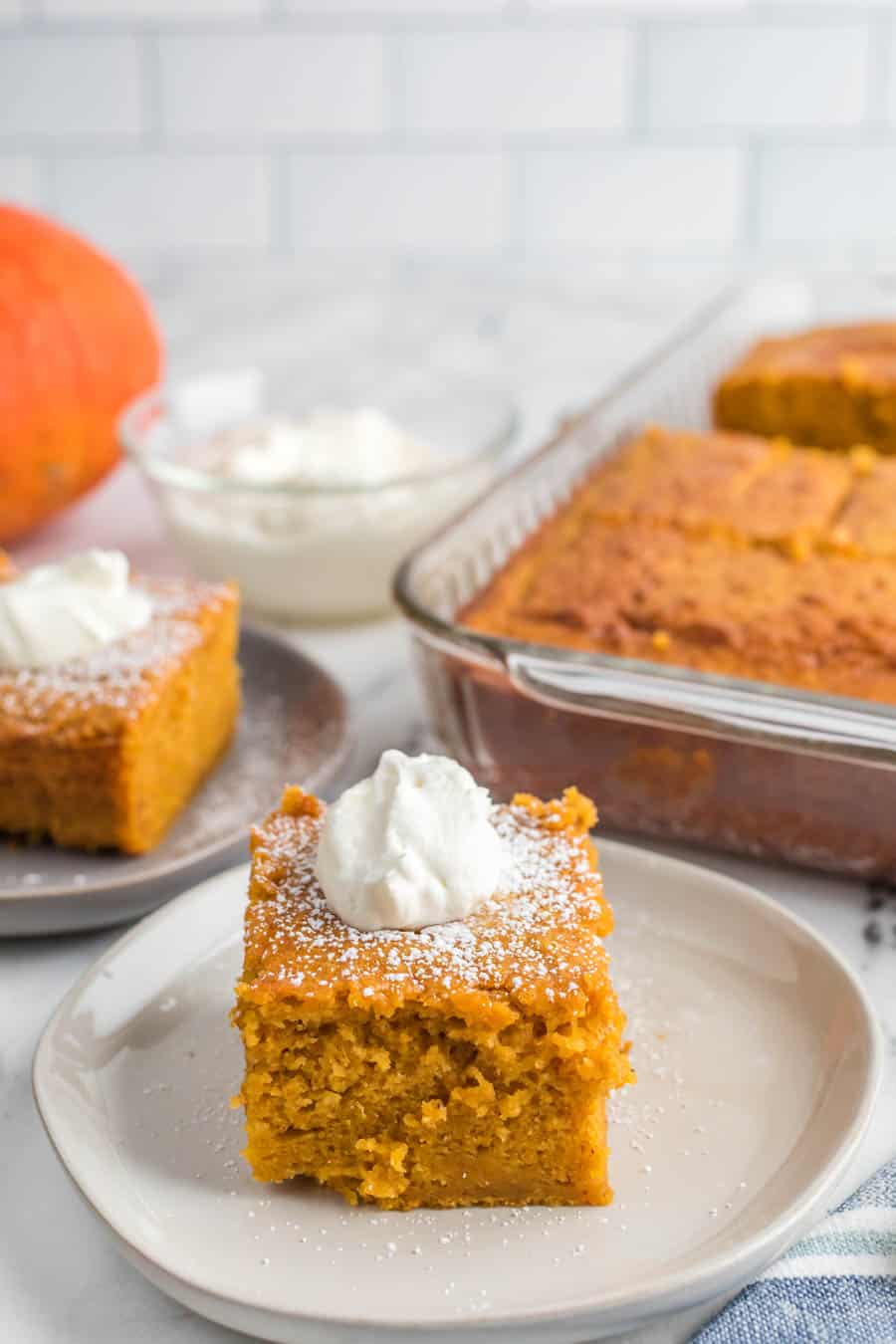 pumpkin cake with whipped cream on top.