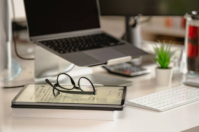 a laptop computer sitting on top of a white desk