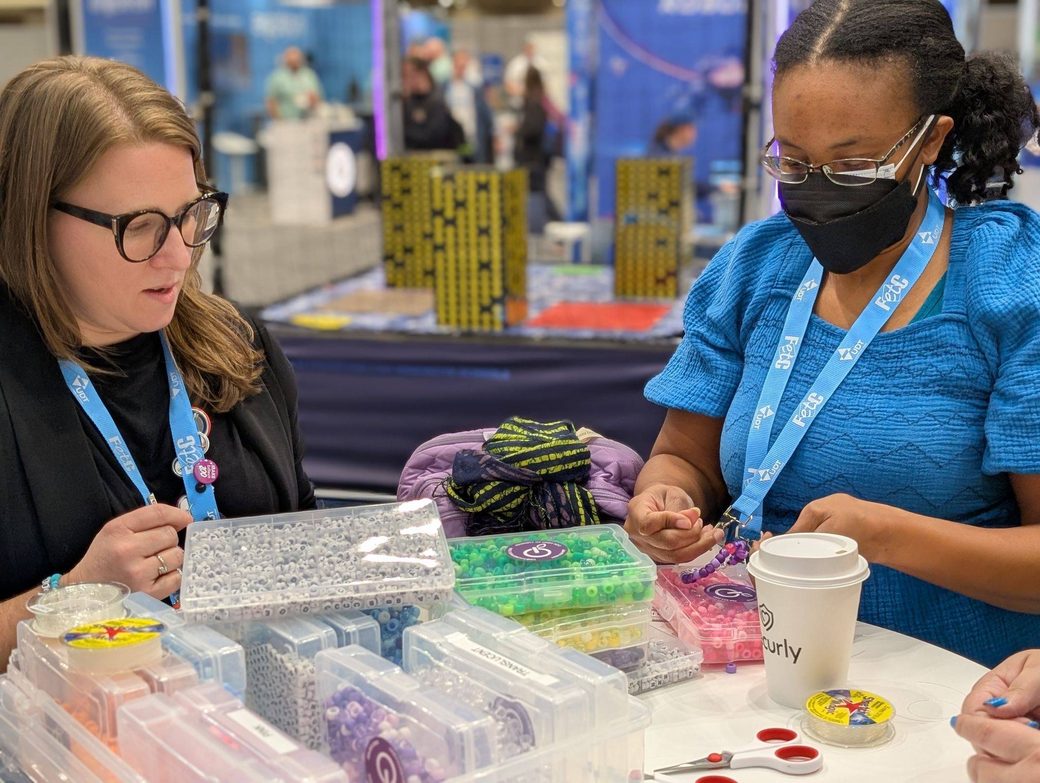 Lindy making friendship bracelets with an attendee
