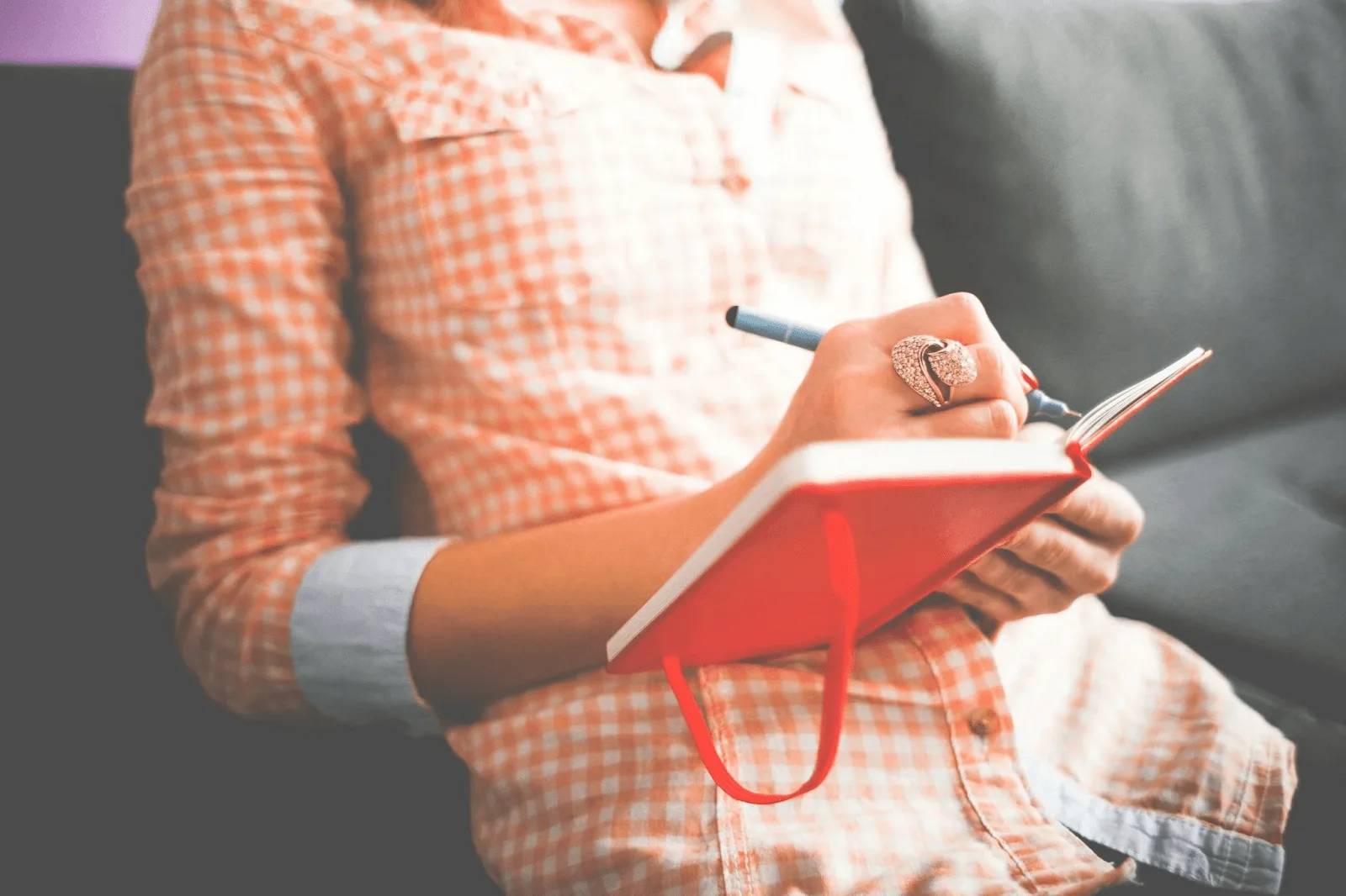 A woman writing journal for her self-discovery