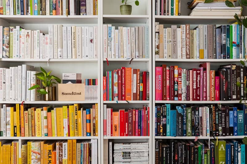 books on white wooden shelf