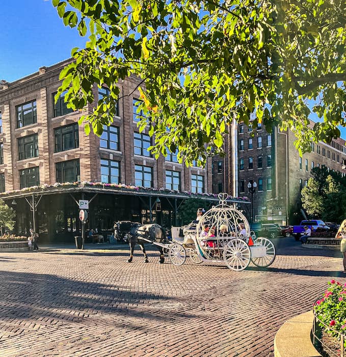 Horse-drawn carriage ride in Omaha Old Market district on a sunny day with historic brick streets