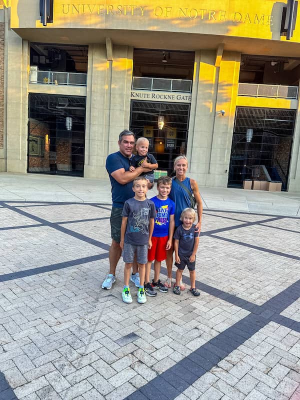 Family of 6 standing in front of the University of Notre Dame football stadium