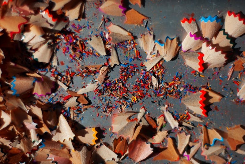 A pile of colored pencils on top of a table