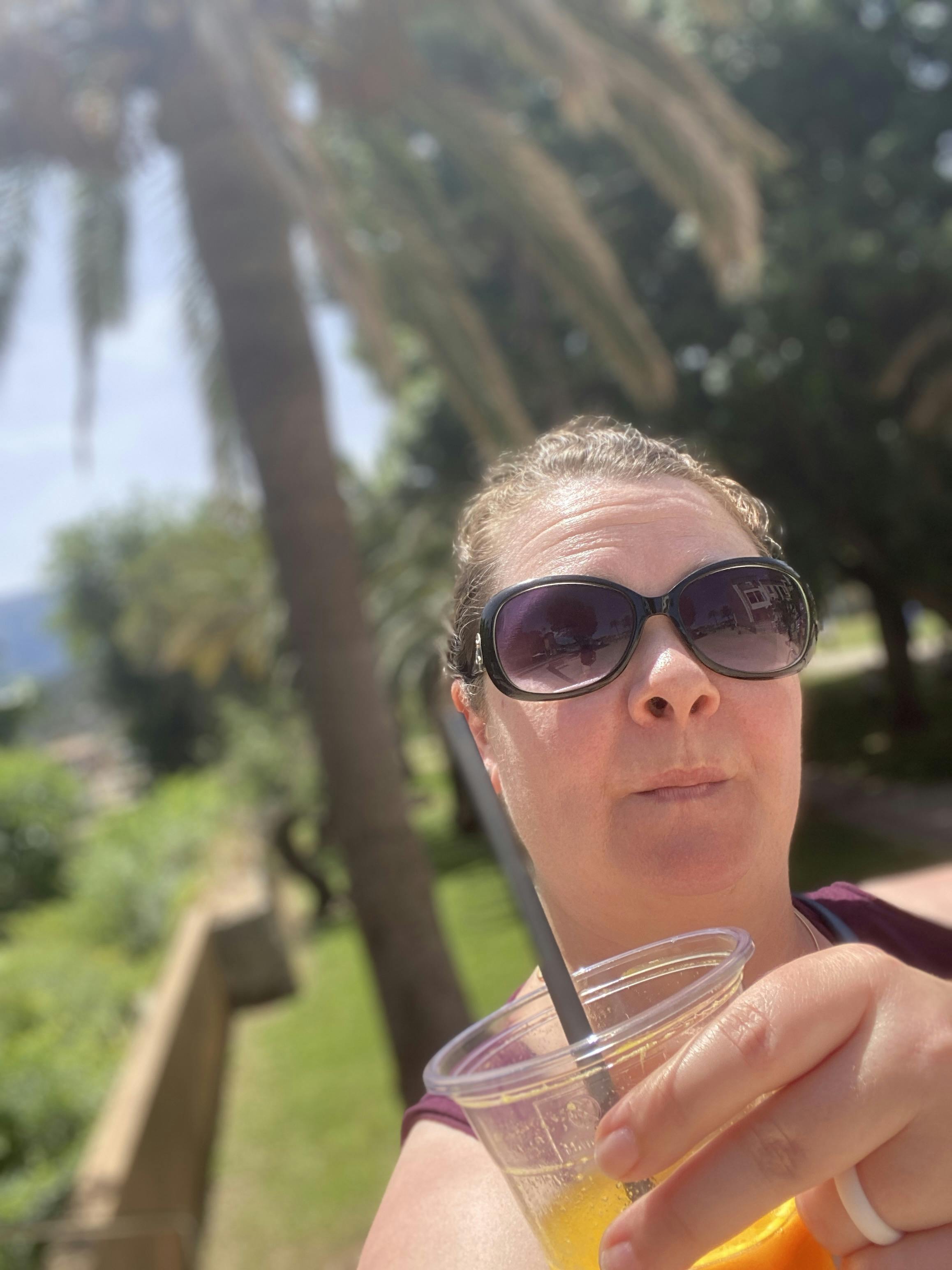 Jen with orange juice on tropical Mallorca