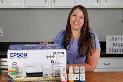 Woman next to an ecotank printer.