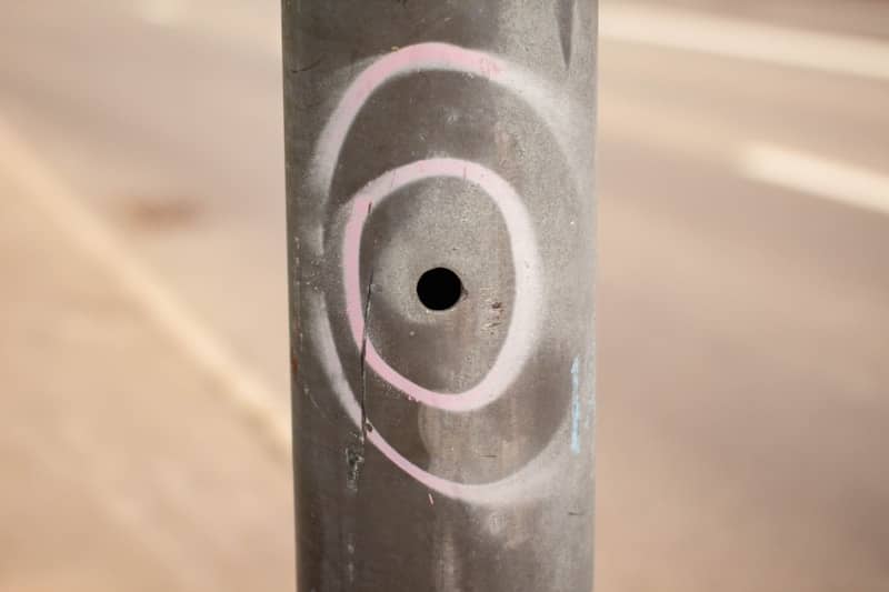 a close up of a pole with graffiti on it