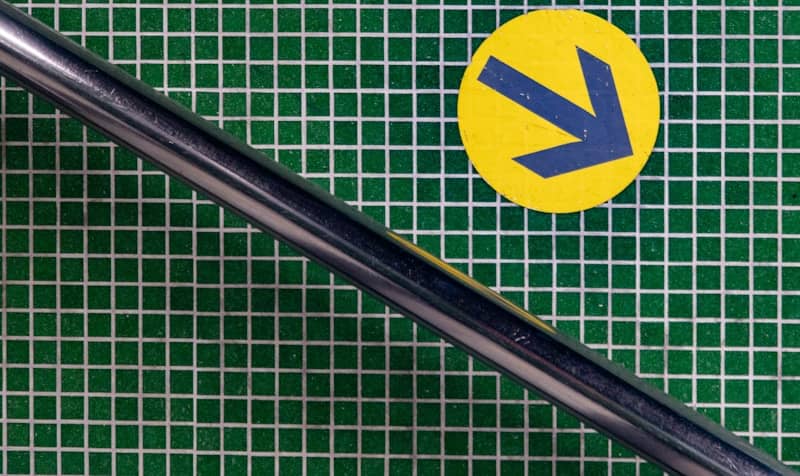 Arrow points right, next to a metal rod.