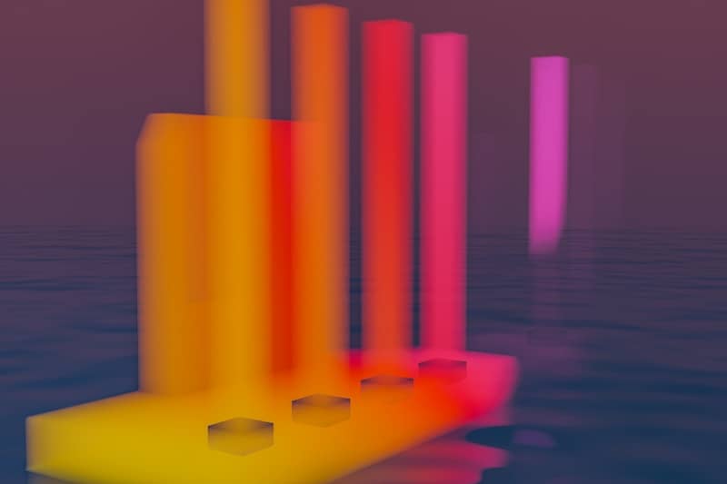 A group of colorful objects floating on top of a body of water