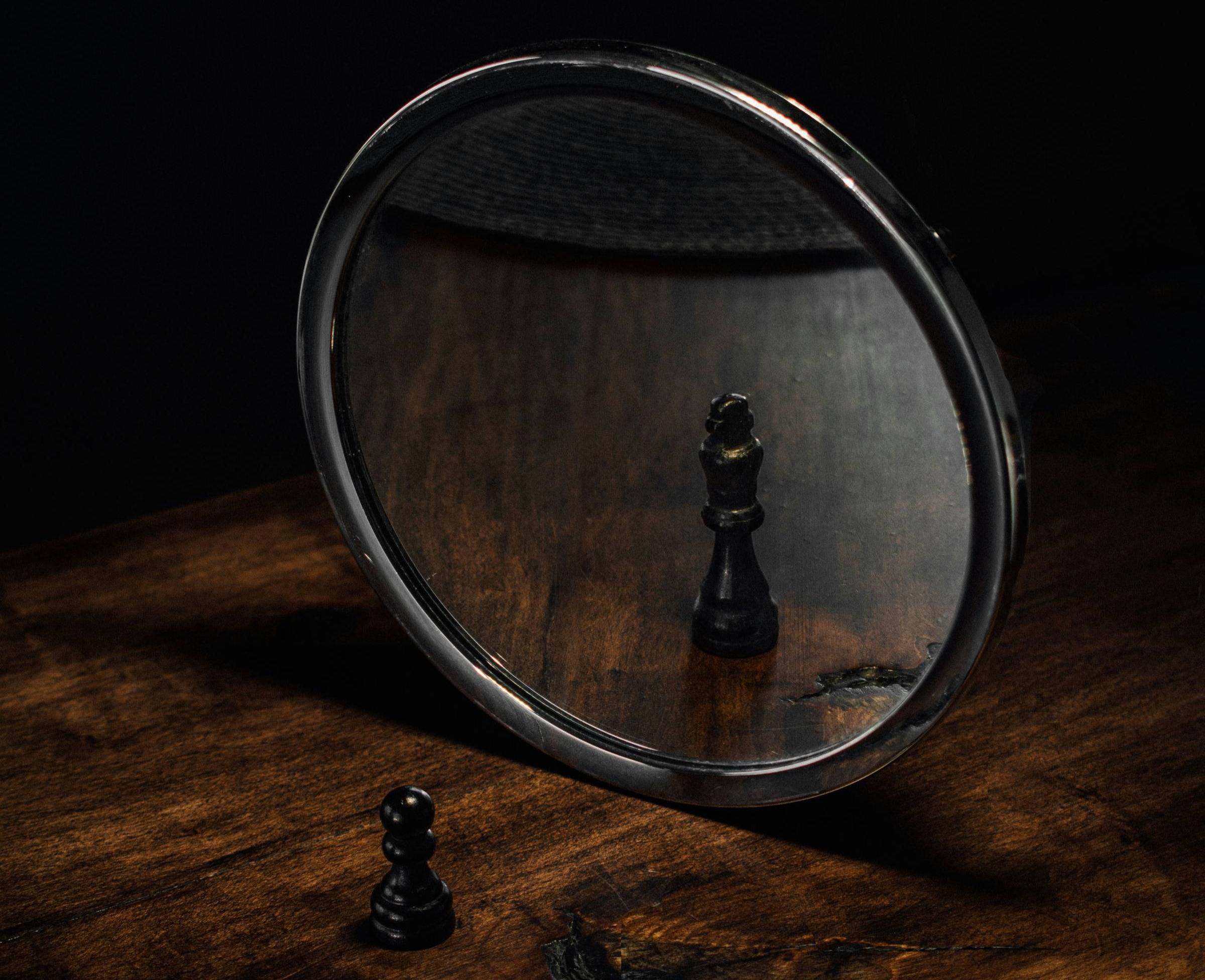 a chess piece looking into a mirror