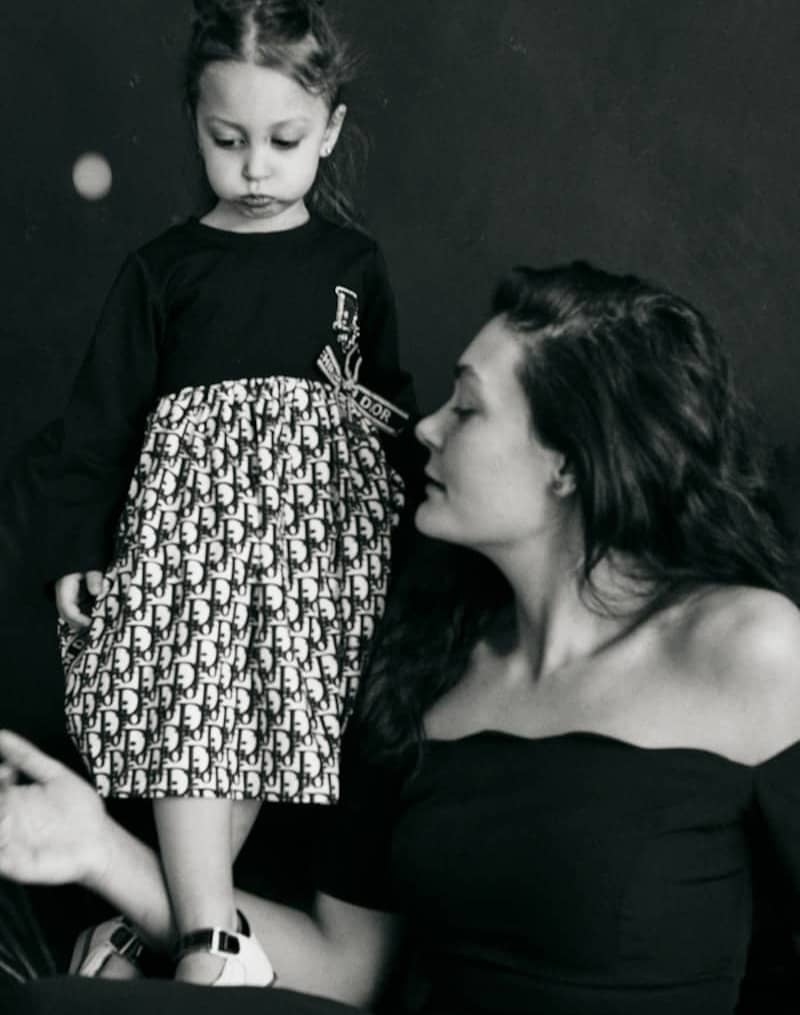 A woman and a young girl in black and white.