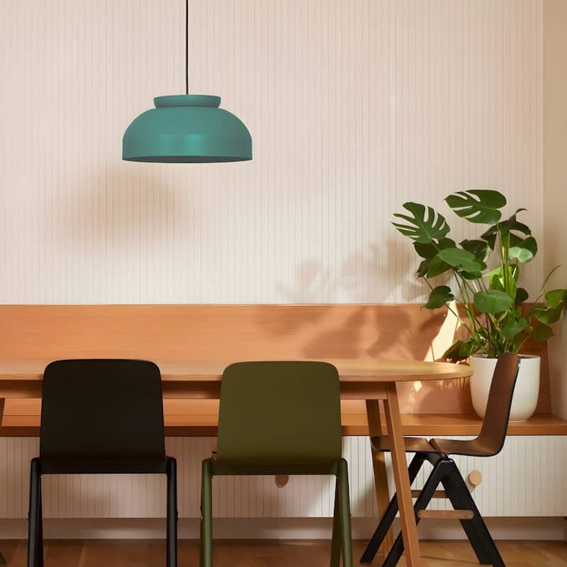 Teal pendant light hangs above modern dining set.