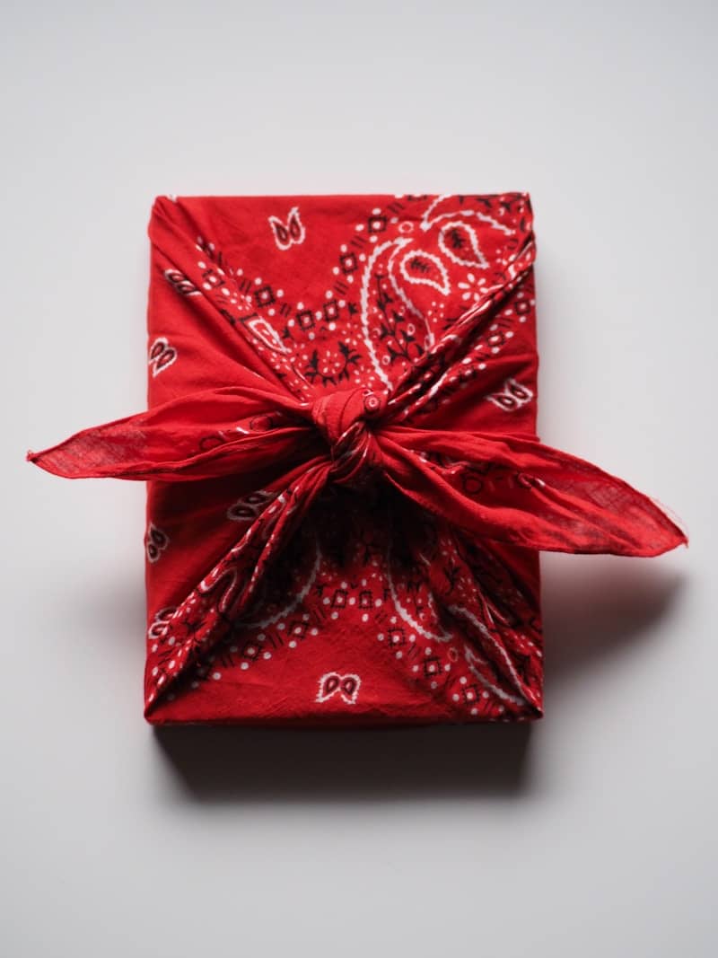a wrapped gift box with a red bow